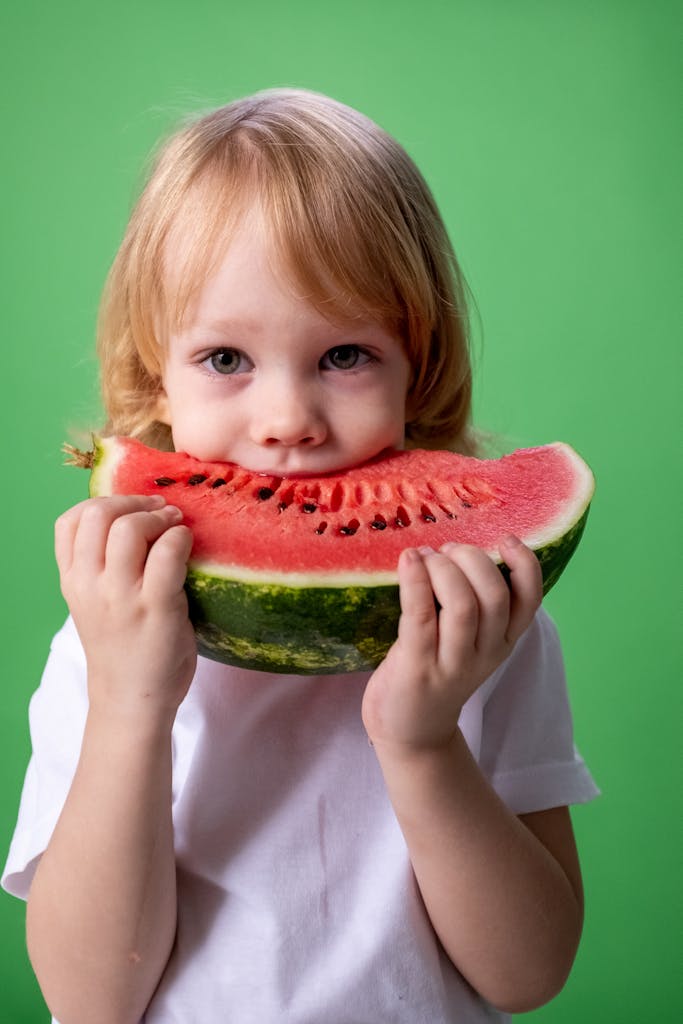 Girl in White Long Sleeve Shirt Holding Watermelon